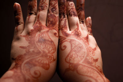 Close-up of human hand against black background