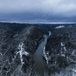 Scenic view of river against sky during winter