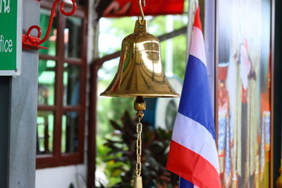 Close-up of bell hanging outside building