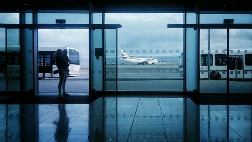 Woman with child standing at airport