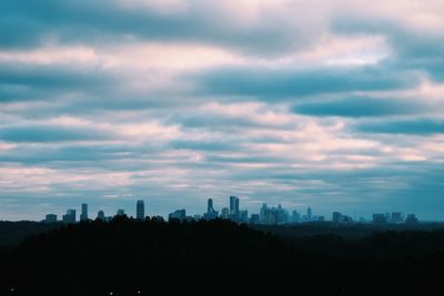 Silhouette buildings against sky during sunset