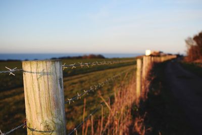 Wooden fence on grassy field