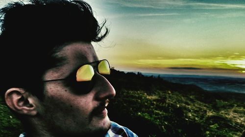 Close-up of man at beach against sky