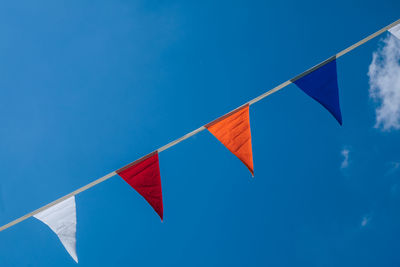 Low angle view of flags against sky