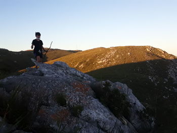 Man standing on rock against mountain