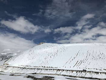 Scenic view of snow covered mountain against sky