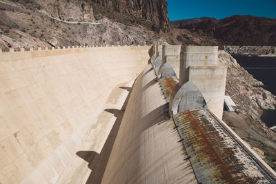 Hoover dam by mountain during sunny day