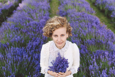 Portrait of woman holding pink flower