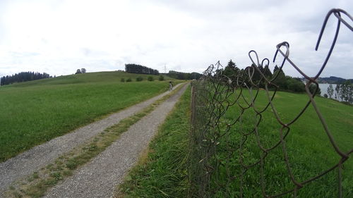 Dirt road passing through rural landscape