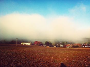 Built structure on field against cloudy sky