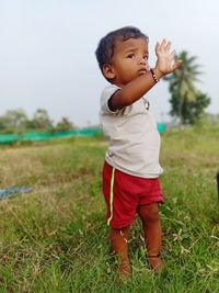 Full length of cute boy standing on field