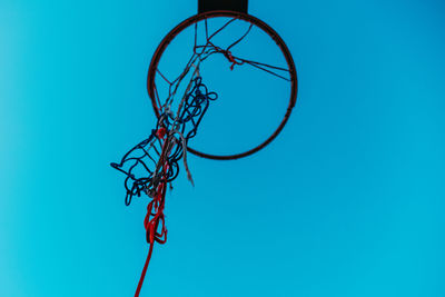 Low angle view of basketball hoop against blue sky