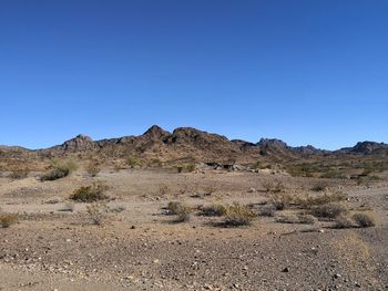 Scenic view of mountains against clear blue sky