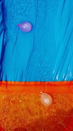 Close-up of blue balloon with swimming pool