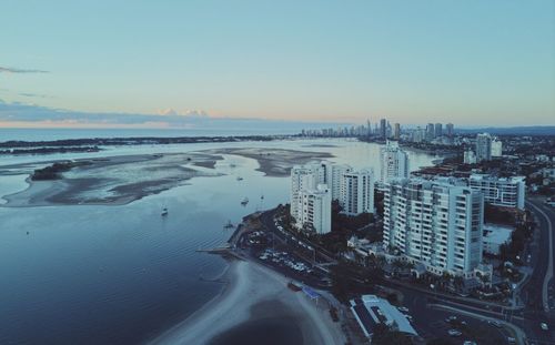 High angle view of buildings by sea against sky