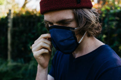 Man wearing mask and hat