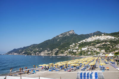 Scenic view of beach against clear blue sky