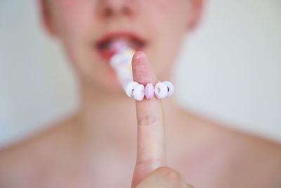 Teenage girl holding necklace