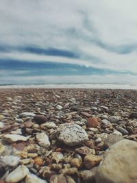 Rocks on beach against sky