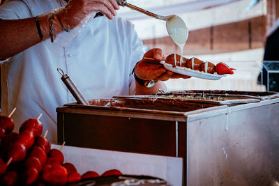 Midsection of man preparing food