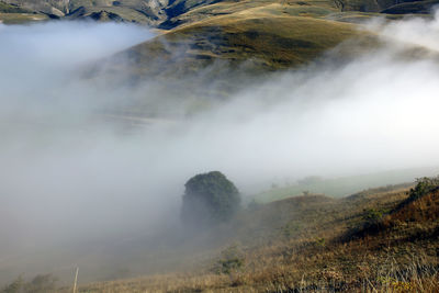 Scenic view of fog over land