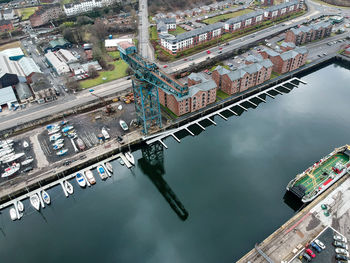 High angle view of boats in city against sky