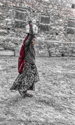 Full length of young woman jumping