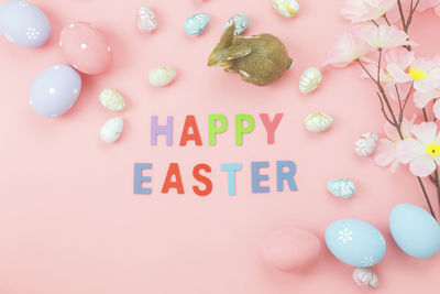 Directly above shot of happy easter text by decorations on table