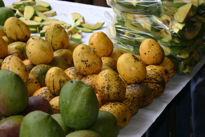 Mangoes on table at market for sale