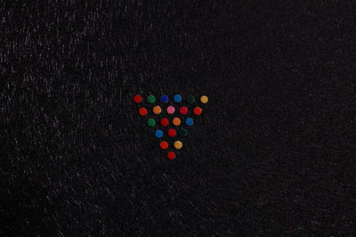 Directly above shot of multi colored pencils over black background