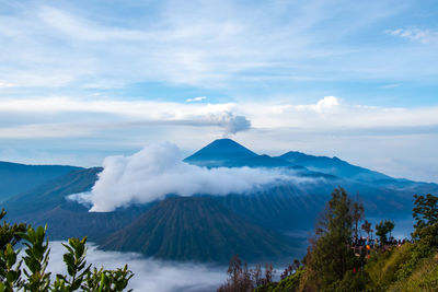 Scenic view of mountains against cloudy sky