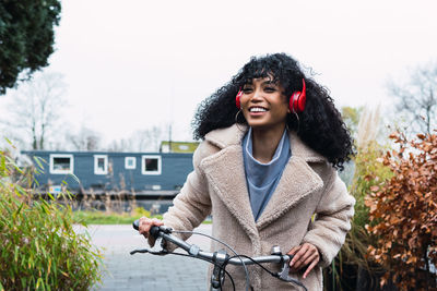 Portrait of young woman with bicycle
