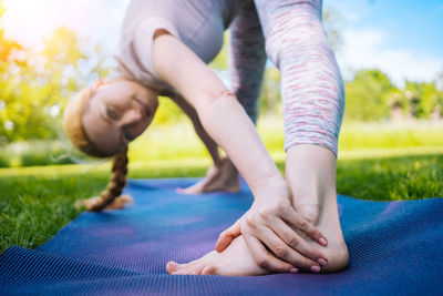 Portrait of woman stretching at park