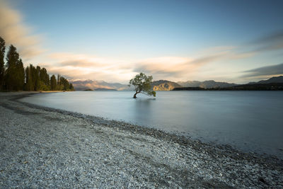 Scenic view of lake against sky during sunset