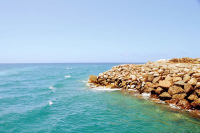 Scenic view of sea against clear blue sky