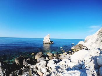 Scenic view of sea against clear blue sky