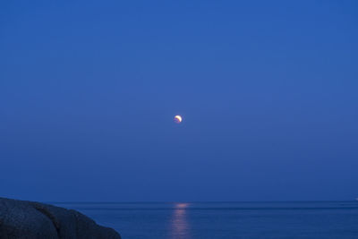 Scenic view of sea against clear sky at night