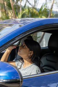 Portrait of young woman in car