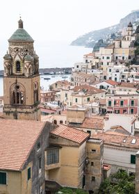 Townscape by sea against sky in city