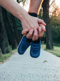 Low section of man tying shoelace