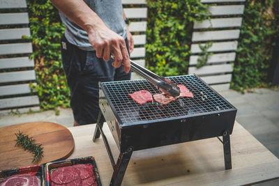 Low section of man preparing food