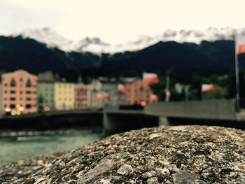 River by buildings against sky