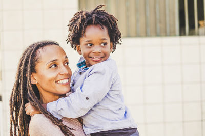 Portrait of happy mother and daughter outdoors