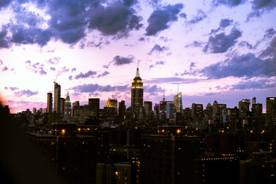 City skyline against cloudy sky