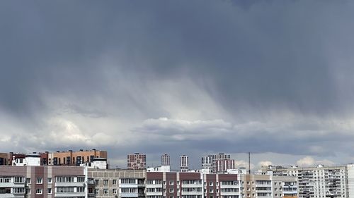 Buildings in city against sky during sunset