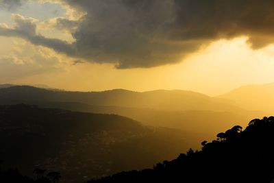 Scenic view of mountains against sky at sunset