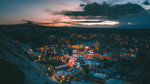 High angle view of illuminated cityscape against sky at night