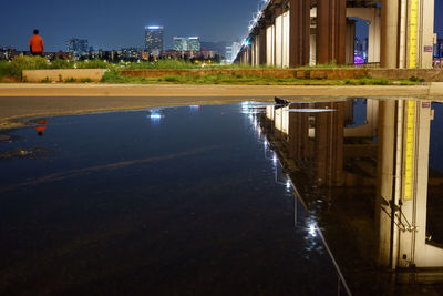 View of canal in city at night