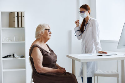 Full length of woman standing on table