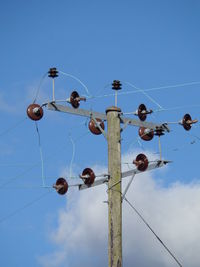 Low angle view of cables against clear blue sky